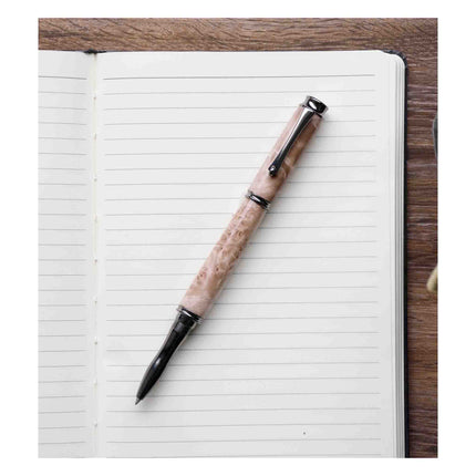 Pen with a decorative handle on an open notebook