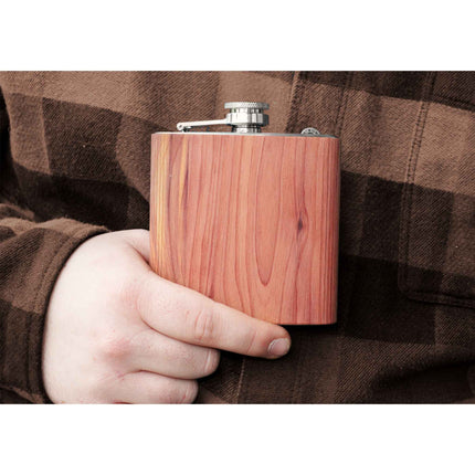 Wooden flask held by a person wearing a plaid shirt