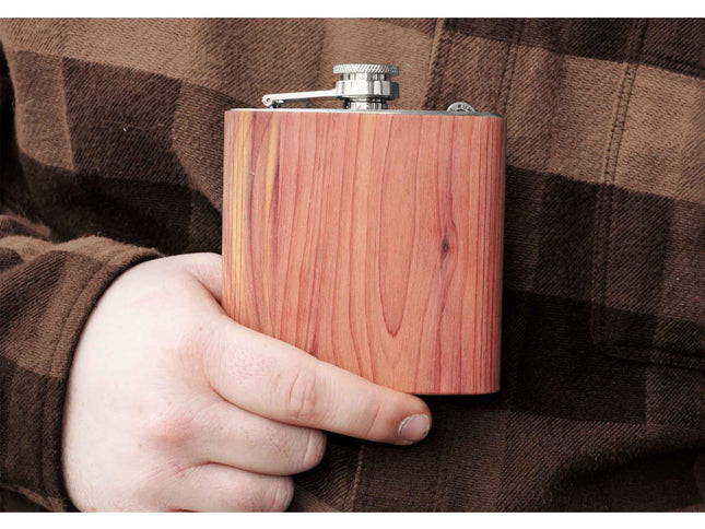 Wooden flask held by a person wearing a plaid shirt
