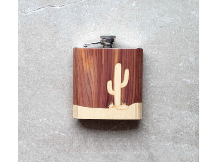 Wooden flask with cactus design on a gray surface