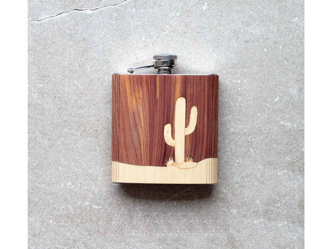 Wooden flask with cactus design on a gray surface