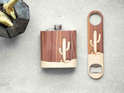 Wooden flask and bottle opener with cactus design on a textured surface.
