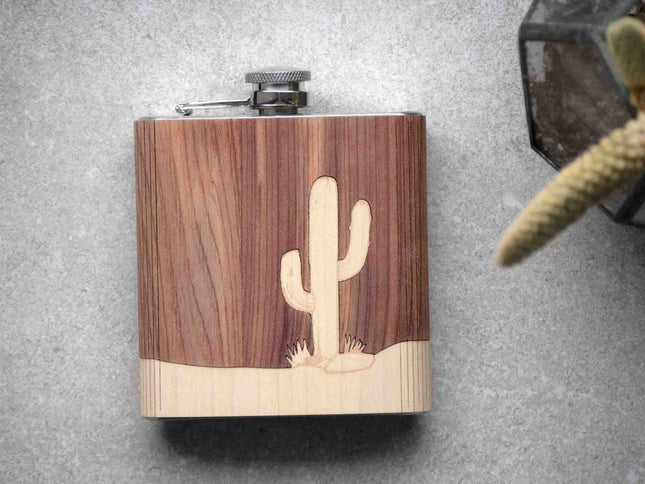 Wooden flask with cactus design on a gray surface