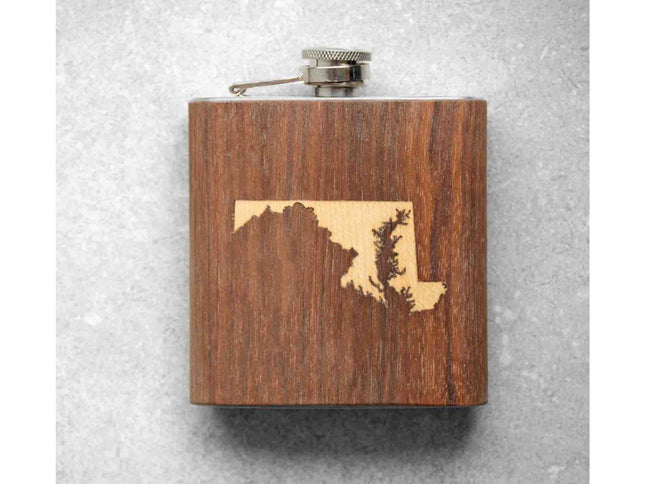 Wooden flask with mountain design on a textured gray background