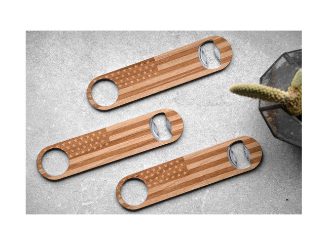 Three wooden bottle openers with American flag design on a gray surface.