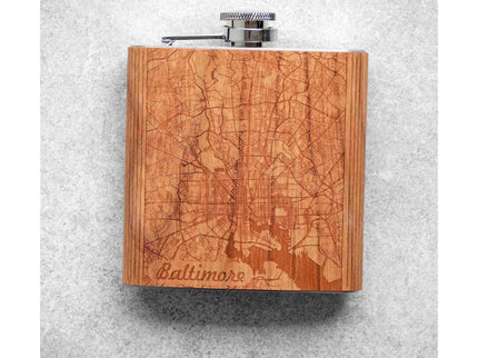 Wooden flask with engraved Baltimore map design on a gray background