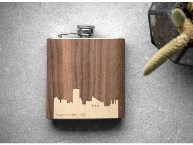 Wooden flask with laser-engraved city skyline on a gray surface