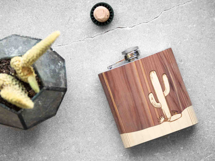 Wooden flask with cactus design on a gray surface
