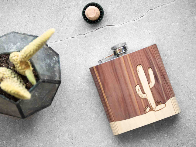 Wooden flask with cactus design on a gray surface