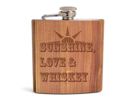 Wooden flask with 'Sunshine, Love & Whiskey' engraving on a white background
