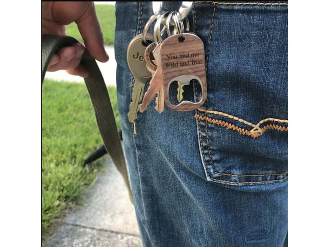 Keychain with bottle opener and keys attached to a person's jeans pocket.