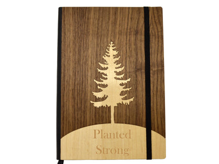 Wooden notebook with tree design and 'Planted Strong' text on a white background