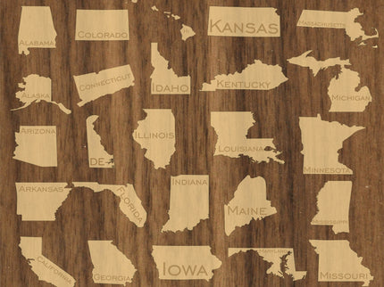 Wooden wall art with cut-out shapes of U.S. states on a wooden background