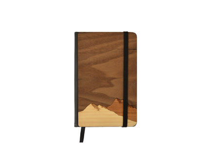 Wooden notebook with mountain design on a white background