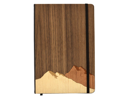 Wooden notebook with mountain design on a white background
