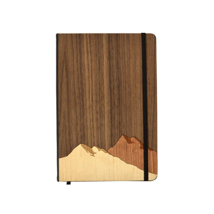 Wooden notebook with mountain design on a white background