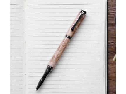 Pen with a decorative handle on an open notebook