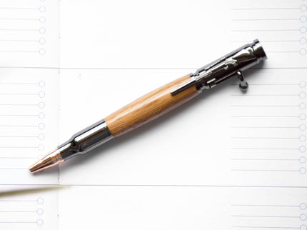 Pen with wooden grip on a lined notebook page