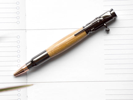 Pen with wooden grip on a lined notebook page