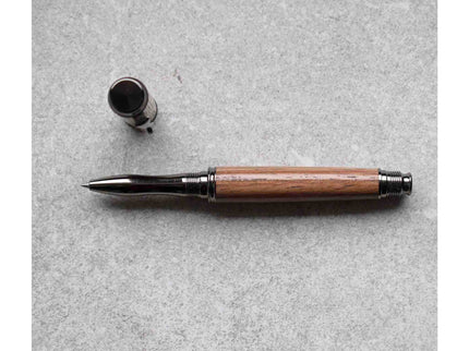 Wooden pen with black accents on a gray surface