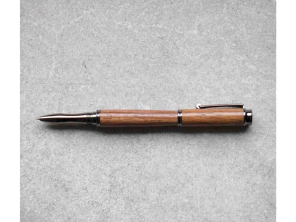 Wooden pen with black accents on a gray background
