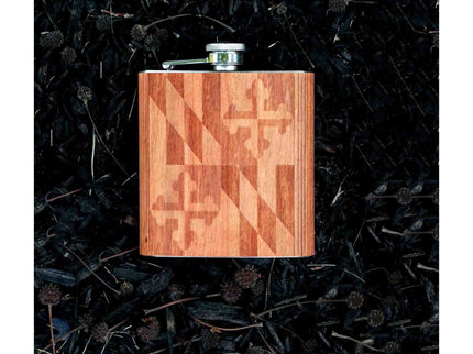 Wooden flask with Maryland flag pattern on a dark textured background