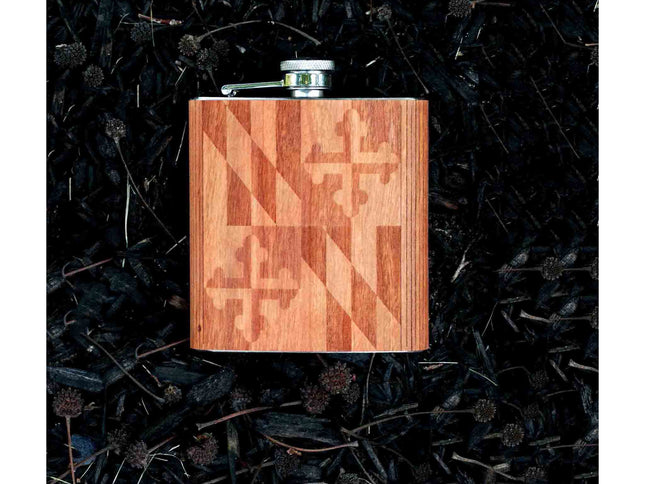 Wooden flask with Maryland flag pattern on a dark textured background
