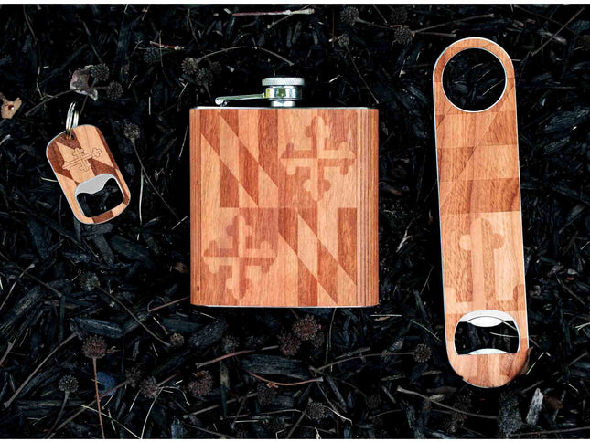 Wooden flask, keychain, and bottle opener set on a dark textured background