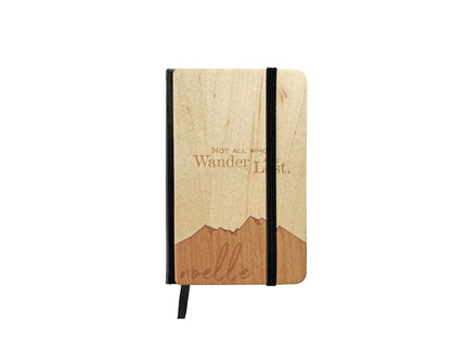 Wooden notebook with black strap closure on a white background