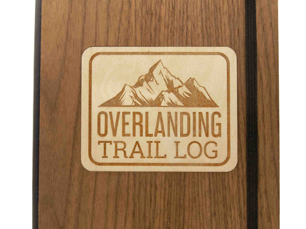 Wooden notebook with 'Overlanding Trail Log' engraving on a white background