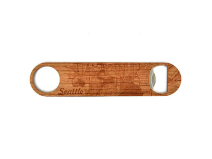 Wooden bottle opener with 'Seattle' engraving on a white background