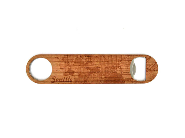 Wooden bottle opener with 'Seattle' engraving on a white background