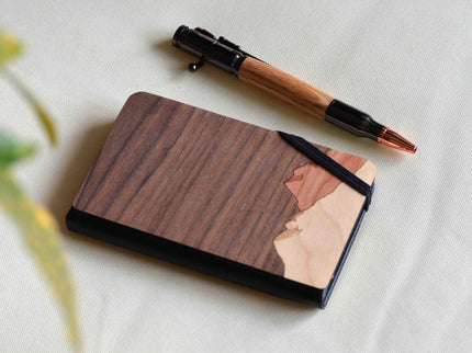 Wooden notebook with a pen on a light fabric background