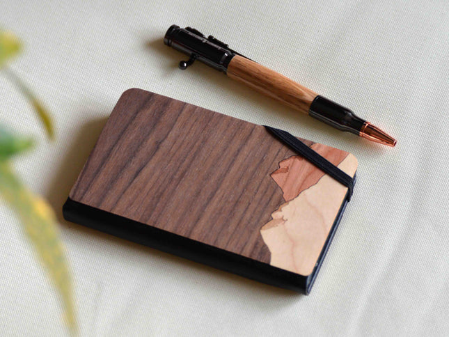Wooden notebook with a pen on a light fabric background