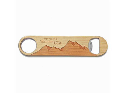 Wooden bottle opener with mountain design and engraved text on a white background