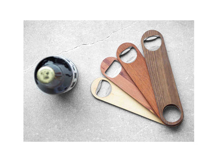 Set of wooden bottle openers on a stone surface with a bottle.