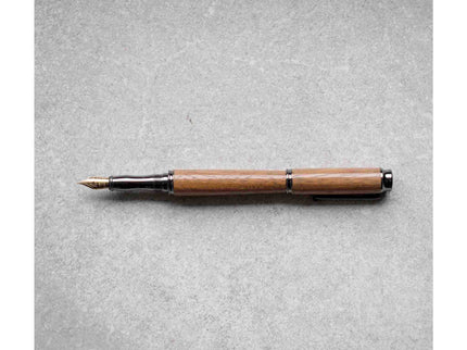Wooden pen on a gray textured background