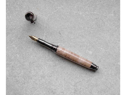 Fountain pen with a marble-like handle on a gray surface