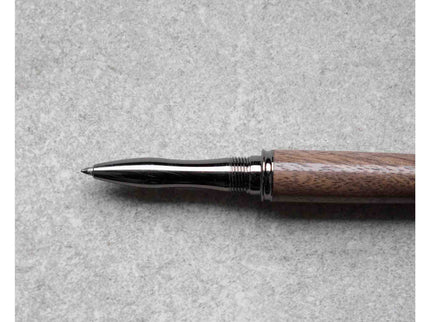 Pen with wooden handle and metallic tip on a gray background