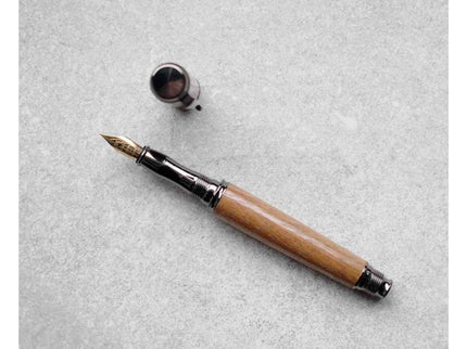 Fountain pen with wooden handle on a gray surface