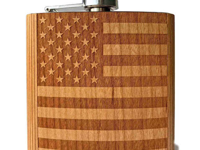 an image of a cherry wood flask, engraved with the American Flag against a white background. Product by Autumn Woods Co