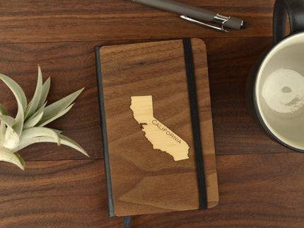 Small wood pocket journal with California state design on wooden desk