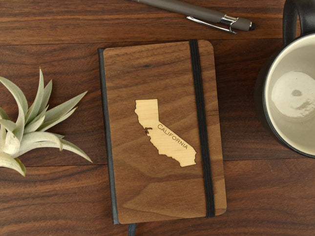 Small wood pocket journal with California state design on wooden desk